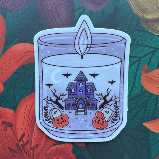 Halloween-themed candle illustration with a haunted house and pumpkins on a floral background