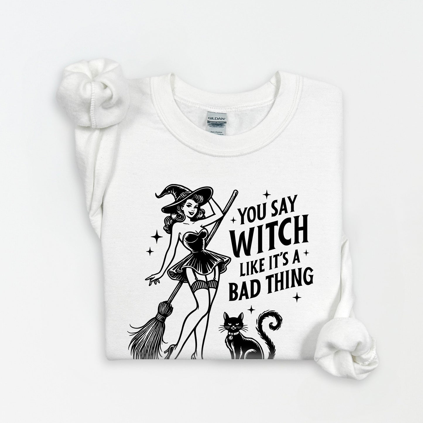 White t-shirt with black graphic design of a witch and text on a white background