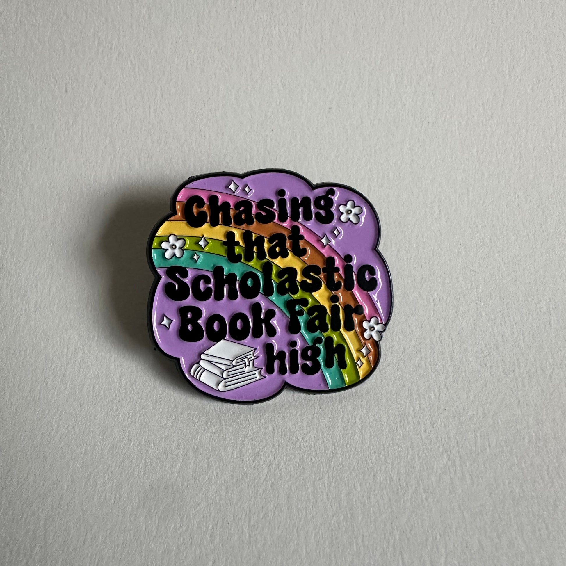Chasing That Scholastic Book Fair High Enamel Pin