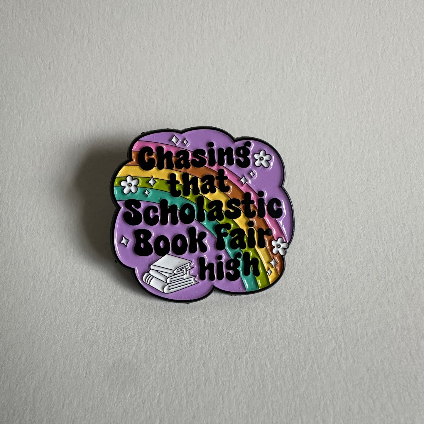 Chasing That Scholastic Book Fair High Enamel Pin, 1.3” x 1.3” - Merry May