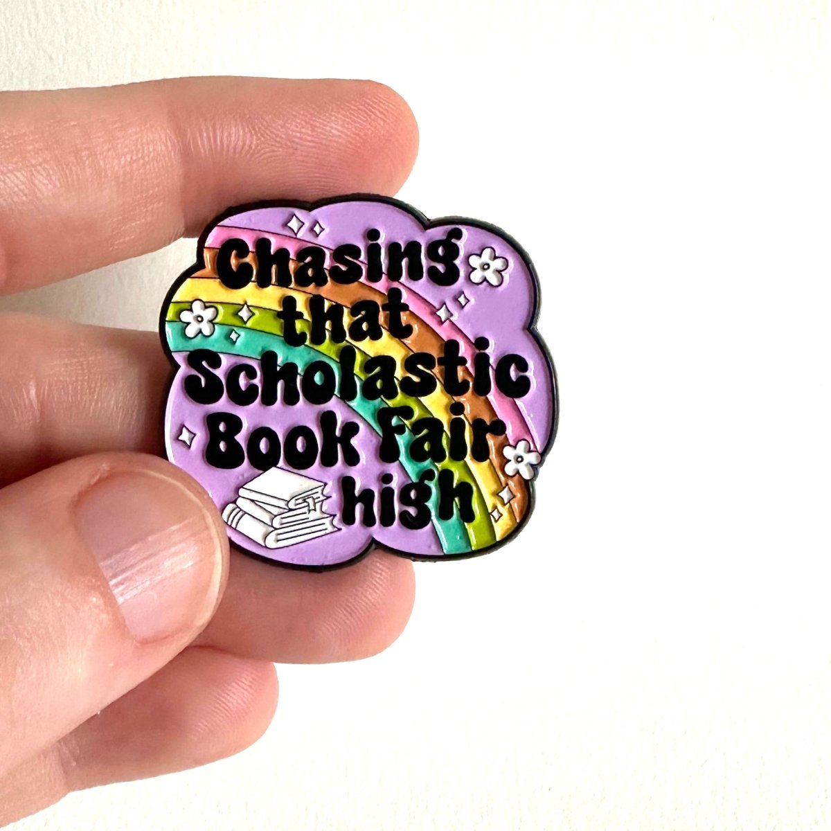 Chasing That Scholastic Book Fair High Enamel Pin, 1.3” x 1.3” - Merry May