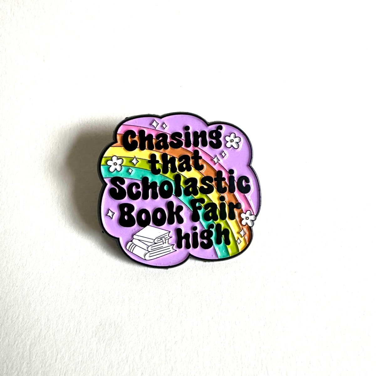 Chasing That Scholastic Book Fair High Enamel Pin, 1.3” x 1.3” - Merry May