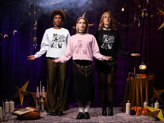 Three individuals wearing witch-themed clothing in a mystical setting with candles and stars.